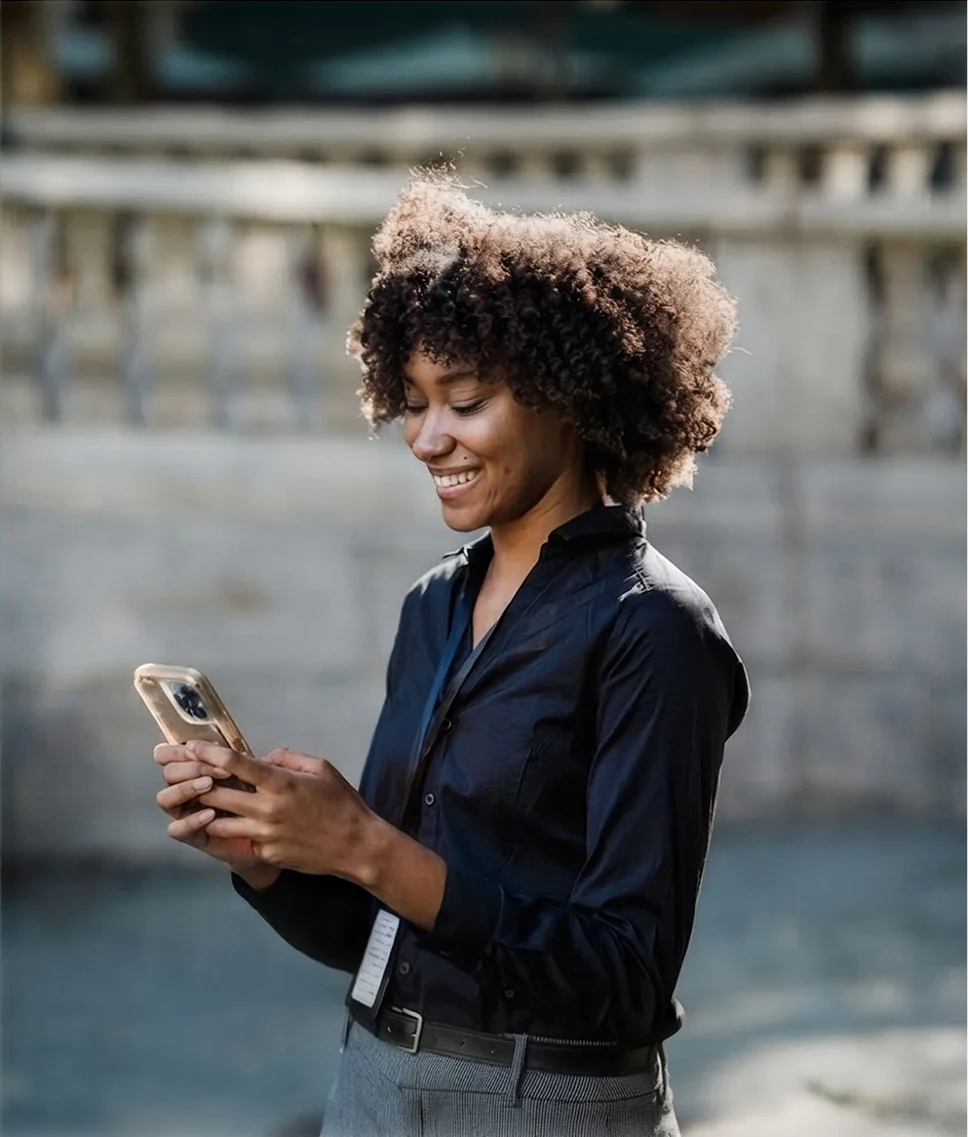 A woman using her phone to access her health benefits